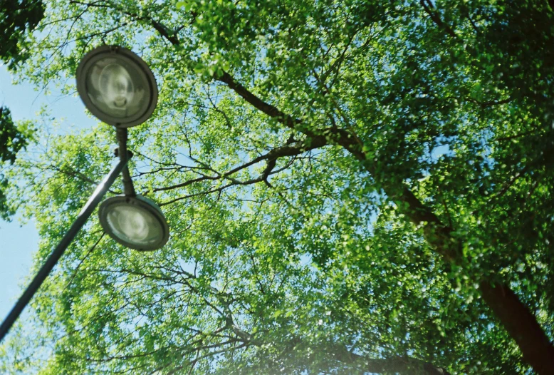 the four streetlights are attached to the metal pole