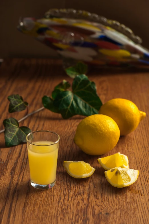 a glass and half a lemon on a table