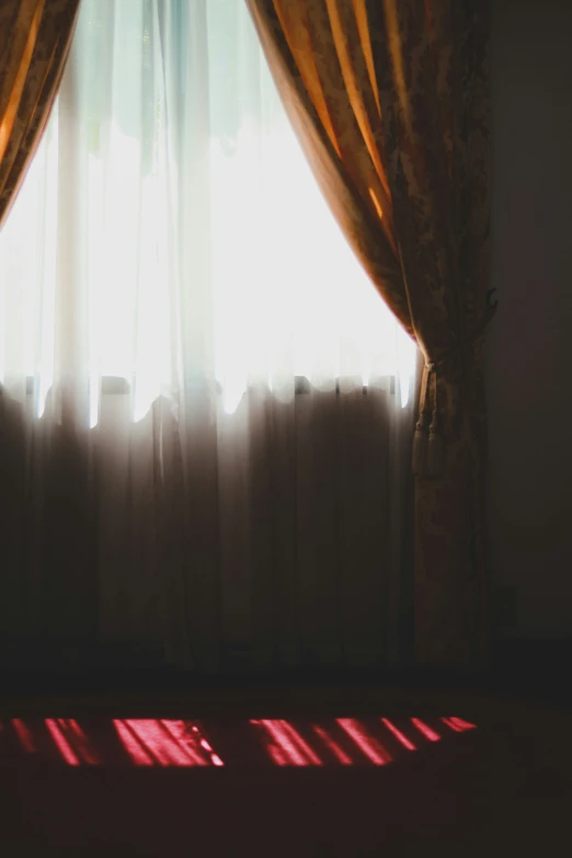 a close up of a curtain with sunlight coming in