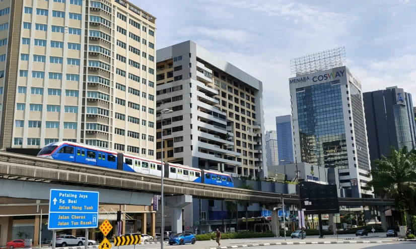 a long passenger train traveling through a city