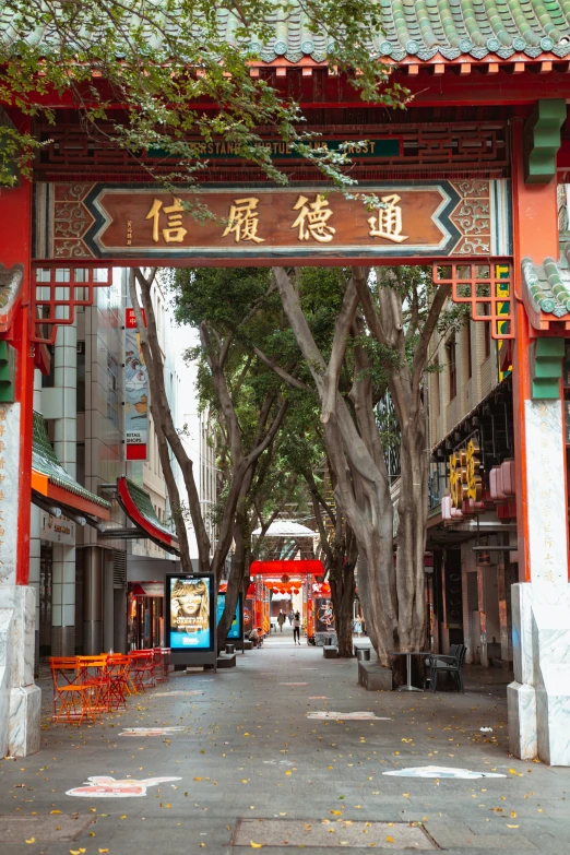 the walkway has red and white pillars with oriental writing on it