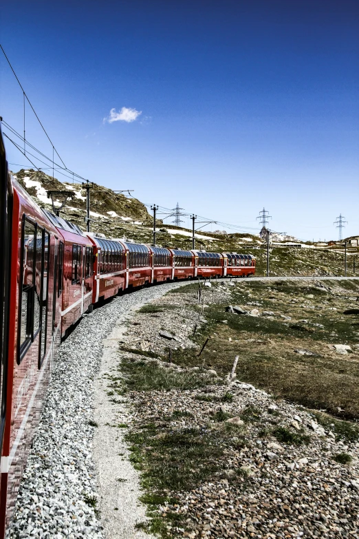 the long train is pulling its wagons behind the car