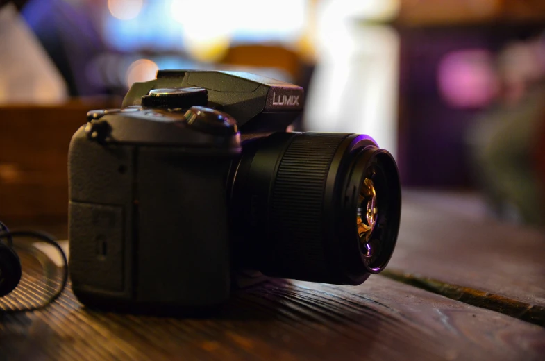 a close up of a black camera with flash attached