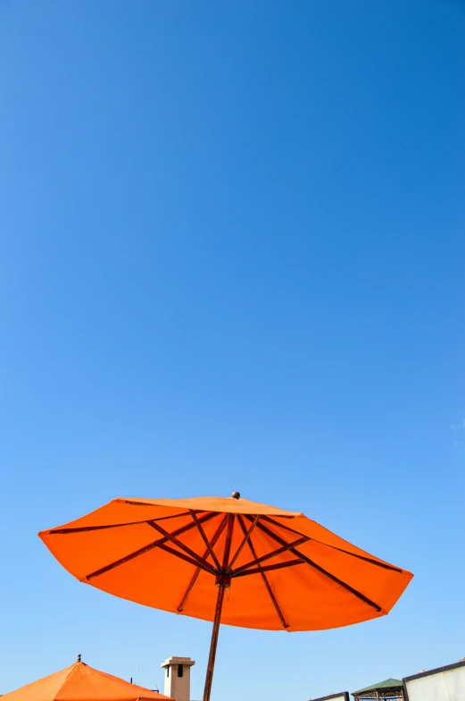 a yellow umbrella in front of the ocean