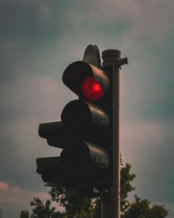 a traffic light hanging off the side of a metal pole