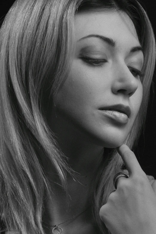 a woman wearing a necklace with diamonds and a cross pendant