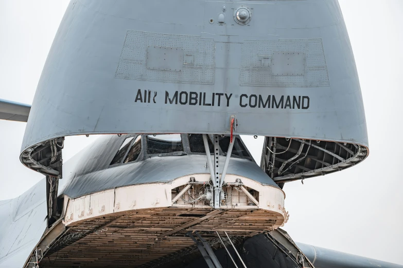 there is a large aircraft with the words ark mobility command written on it