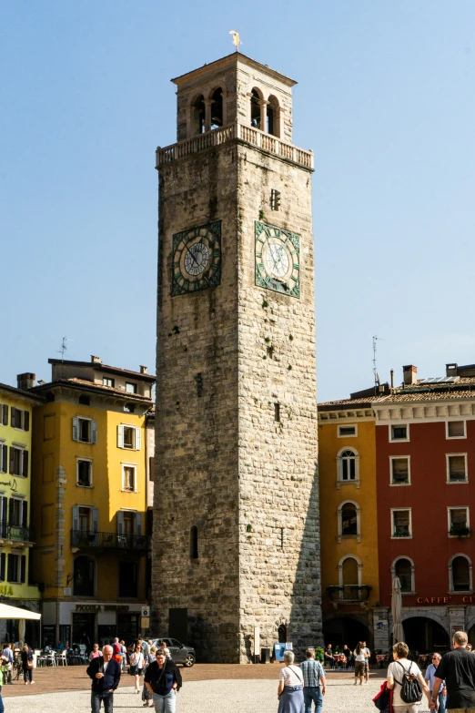 a clock tower in a courtyard that looks like an old clock