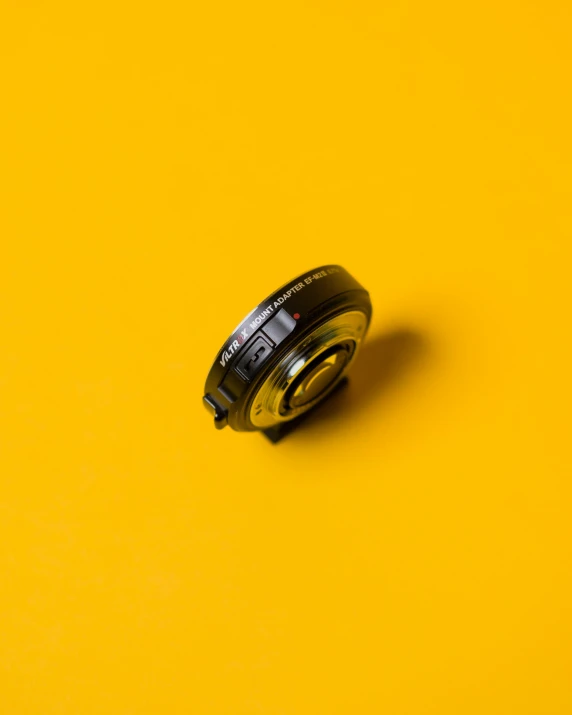 an open lens sitting on top of a yellow table