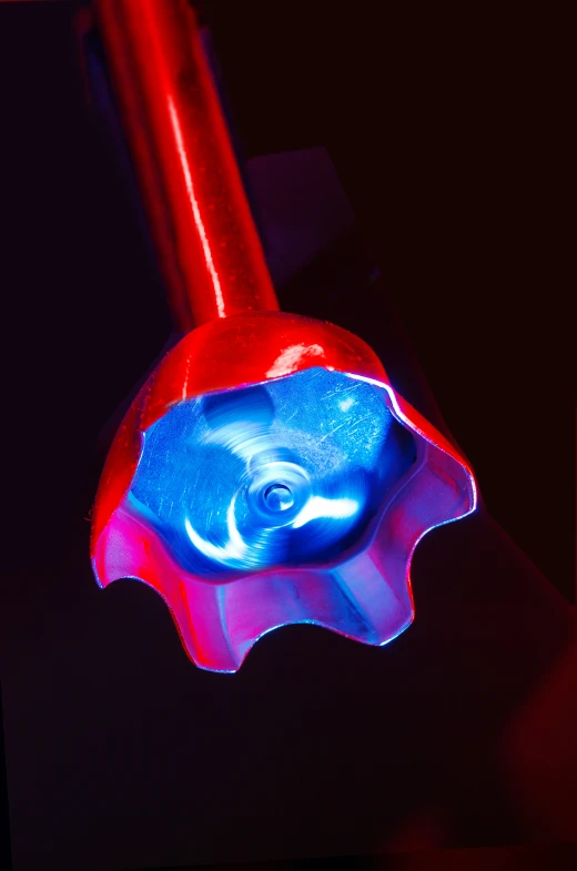 a red blue and black object that is upside down