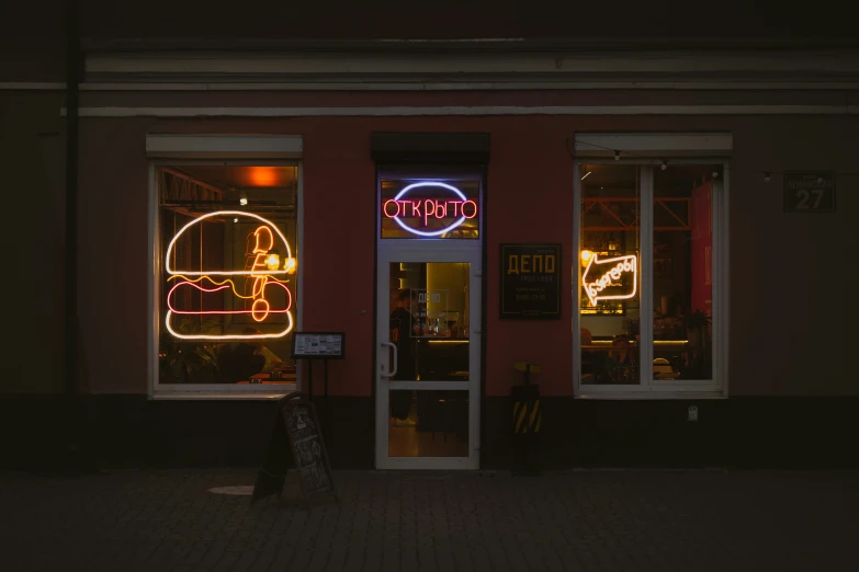 a lit store front with the sign lit up