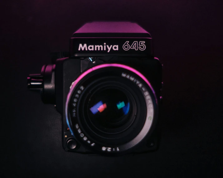 a camera with a lens attached to it's body and a name on it