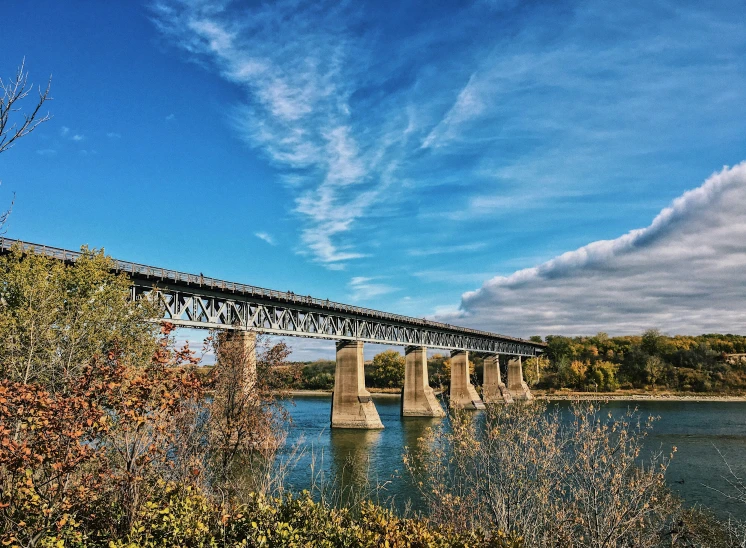 a very long bridge that is spanning a river