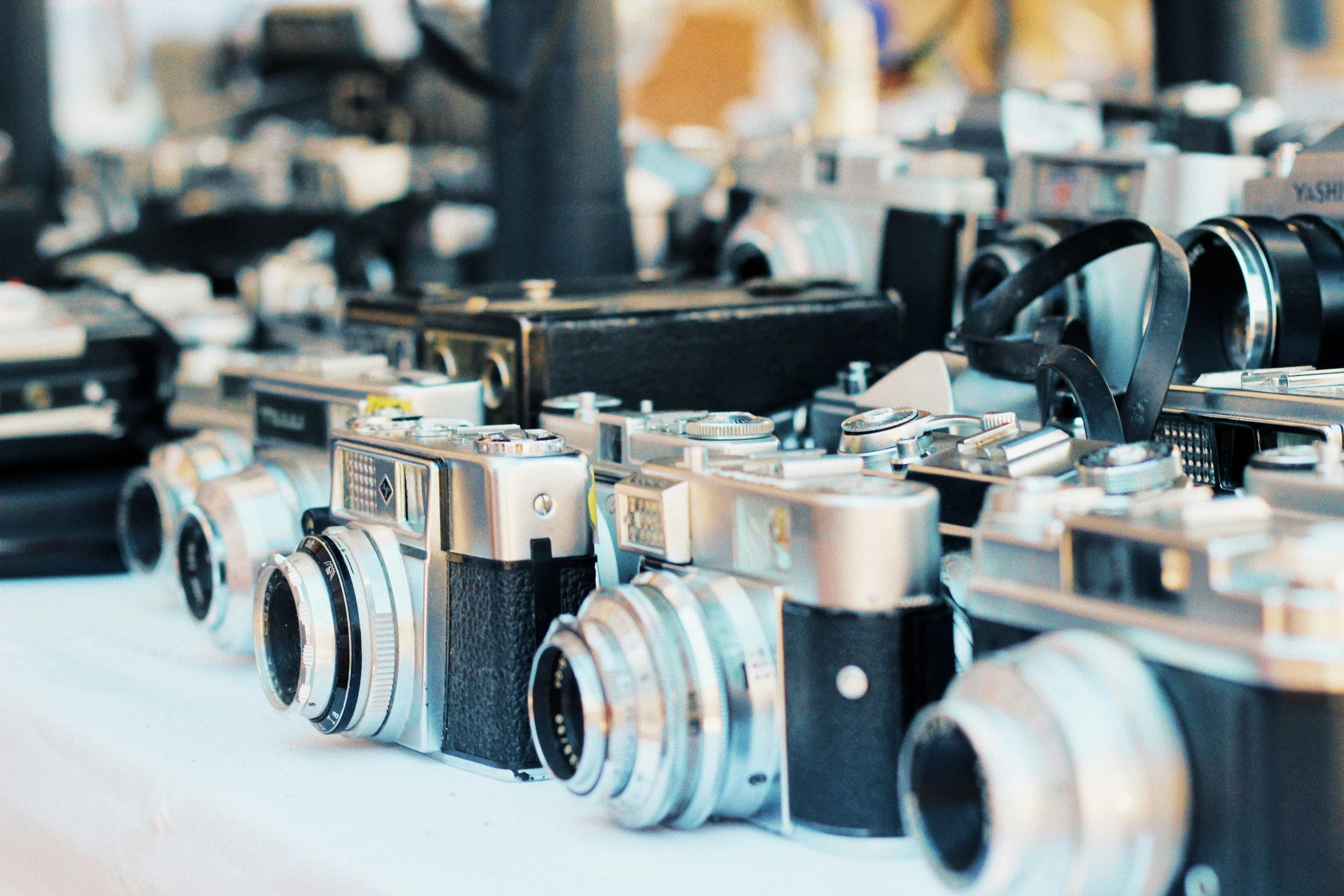 a table topped with lots of different cameras