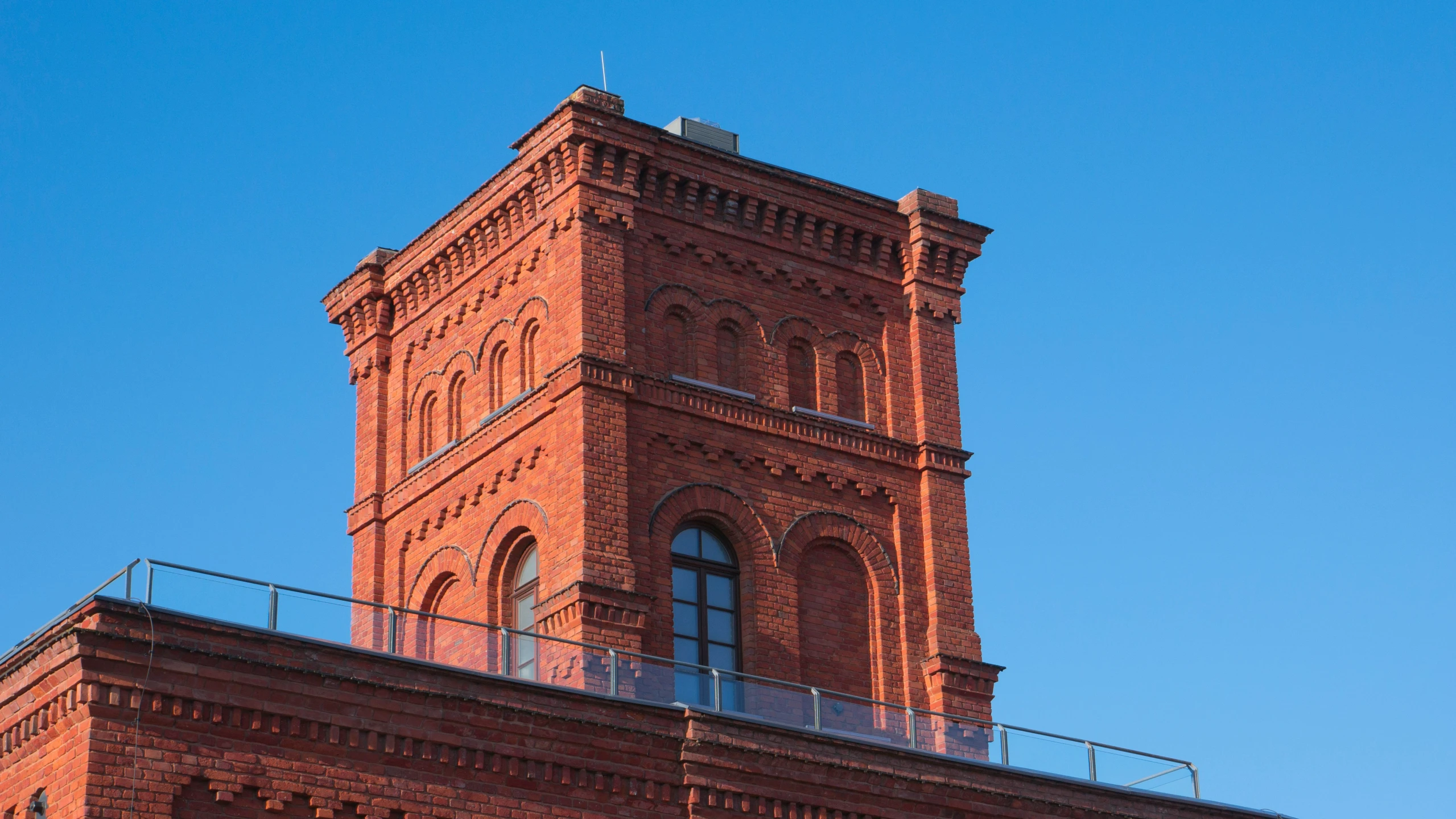 the brick building with a balconies has a glass balcony