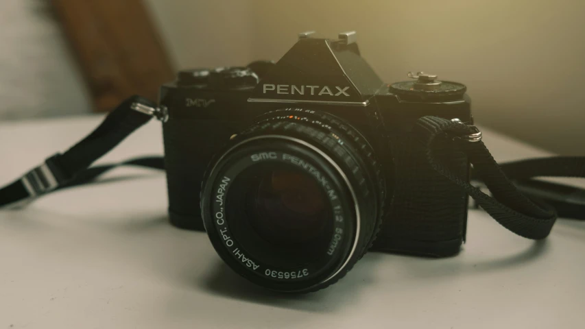 an old film camera is shown sitting on a table