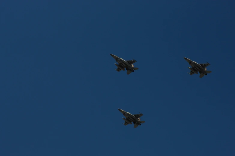 four planes fly in formation together in the sky