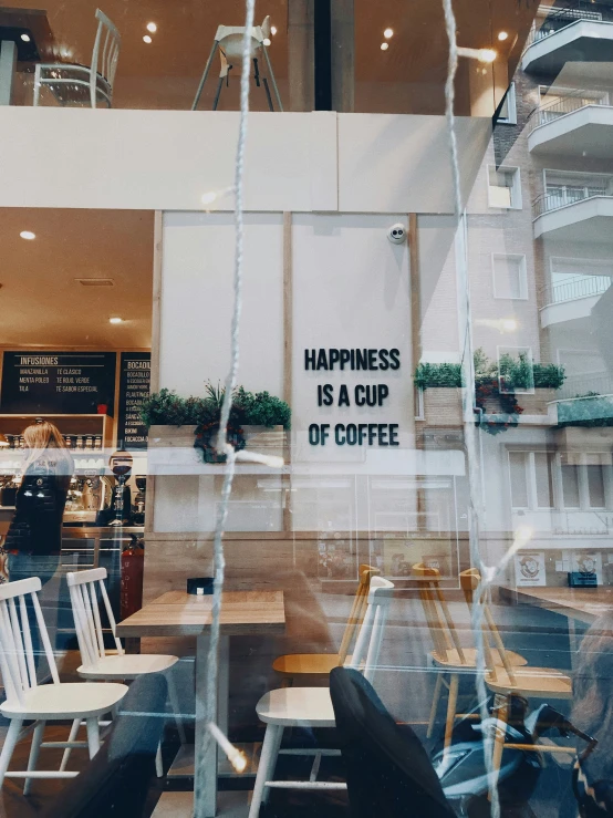 a restaurant with a sign that reads happiness is a cup of coffee