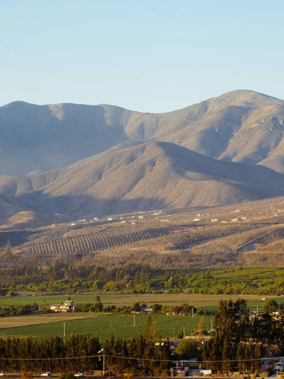 an overview of a rural landscape with the mountains in the background