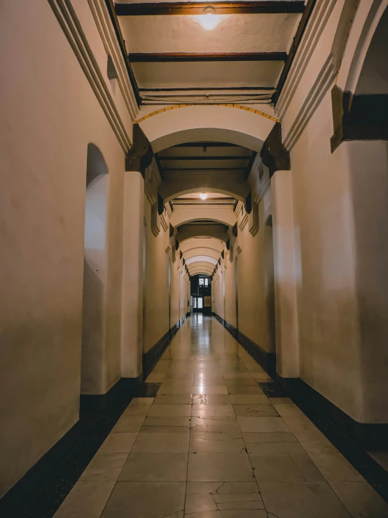 an empty building with lights on either side and the floor