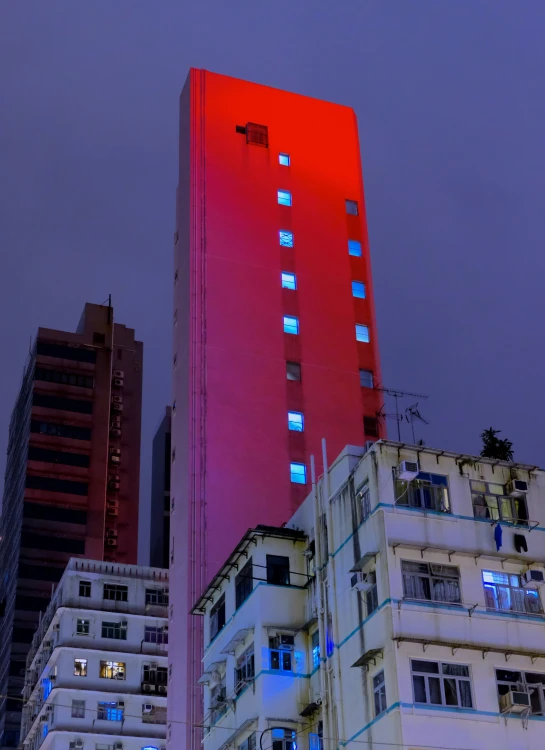 the building has many windows in the building at night