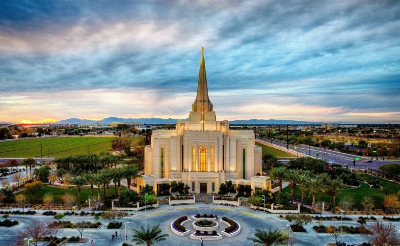 the temple with its tall spire lit up at dusk