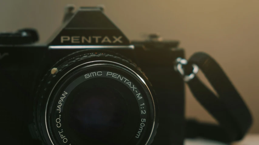 an old pentax camera with some fine grain added