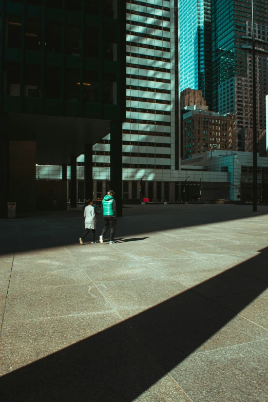 a couple of people walking down a street