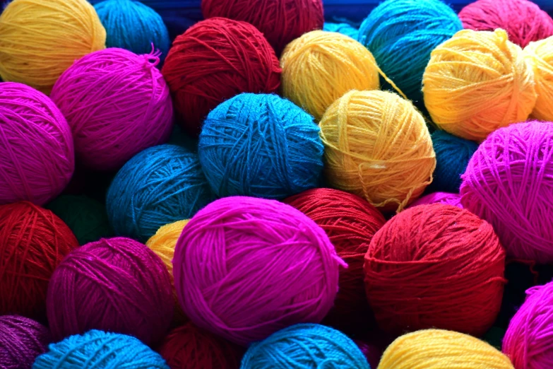 balls of yarn are all different colors on display