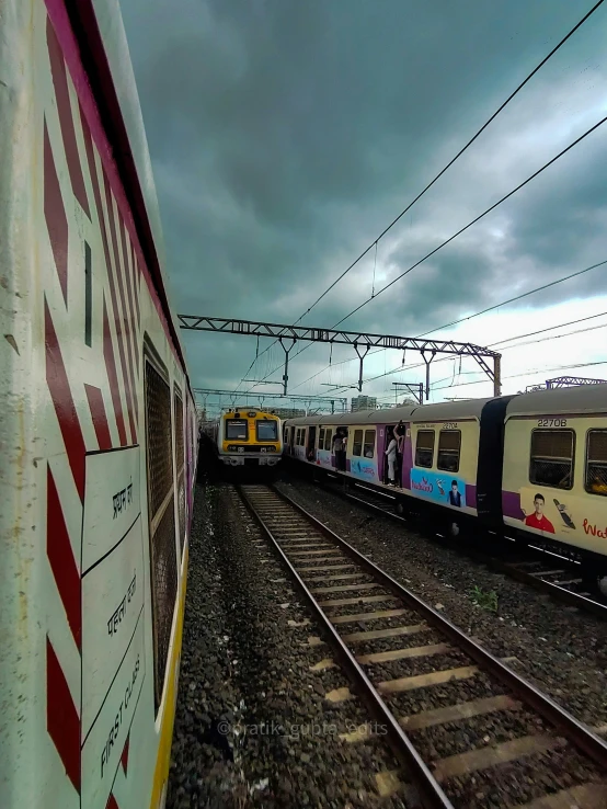 a train riding through an industrial district in the middle of the afternoon