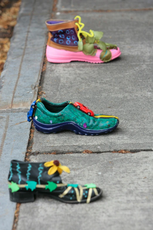 there are three shoes that have colorful designs on them