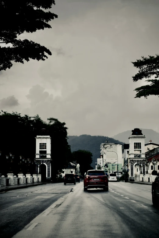 a black and white po of a street with parked cars