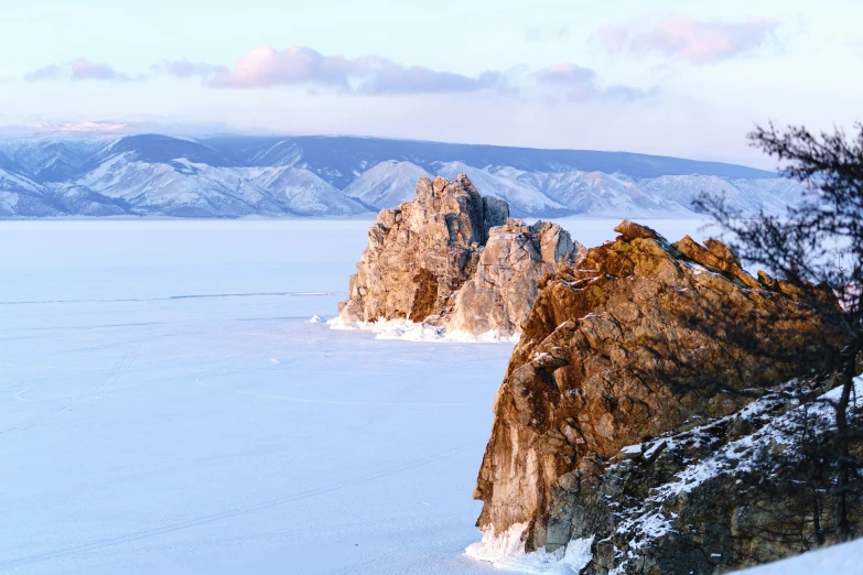 snow covering the ground with mountains and rocks