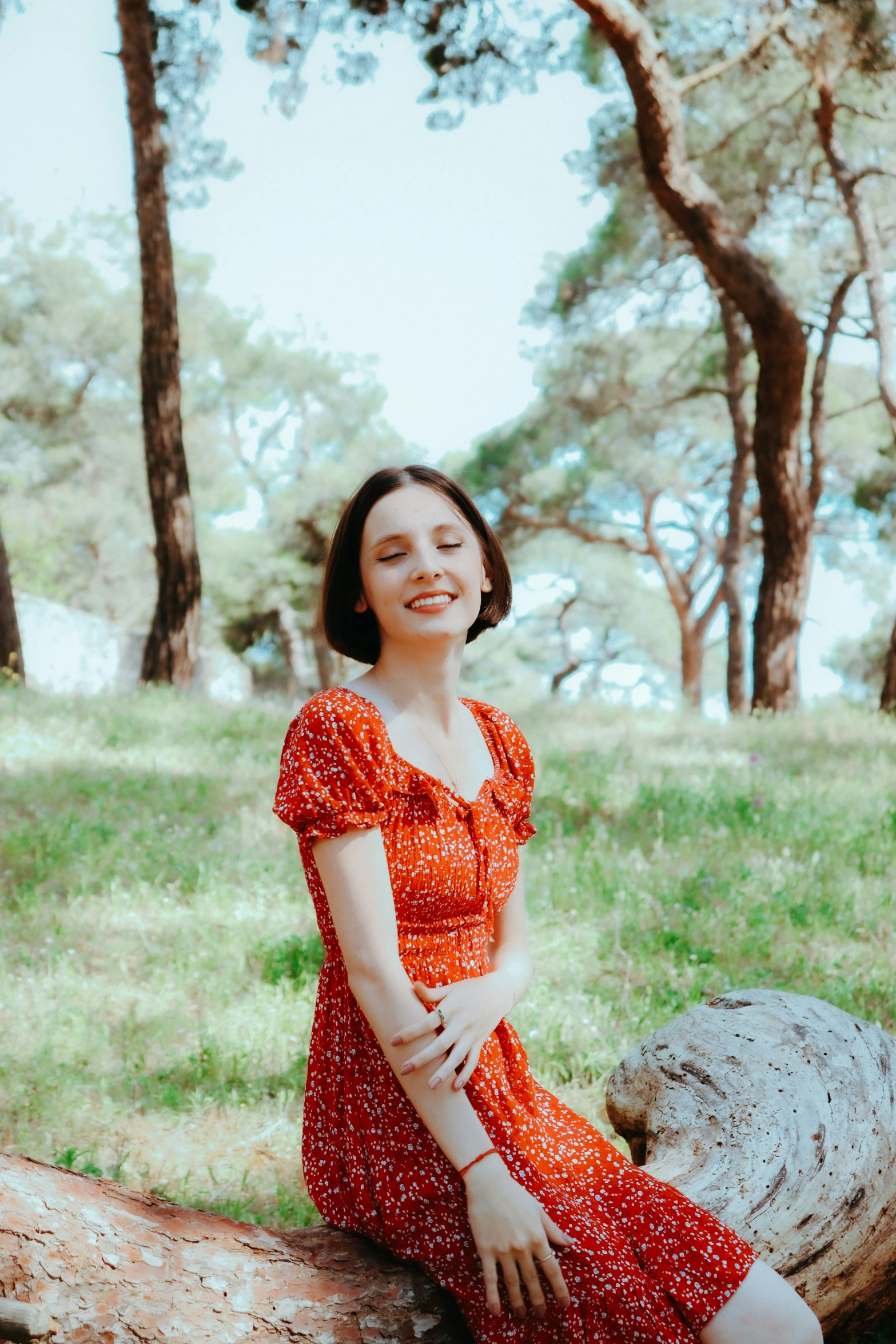 an older woman sitting in the woods