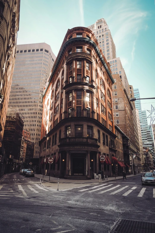 a busy city street intersection, with a very large building in the middle