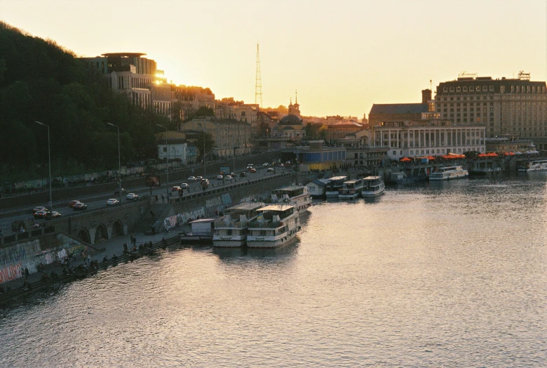 a bridge spanning a waterway with boats and tall buildings