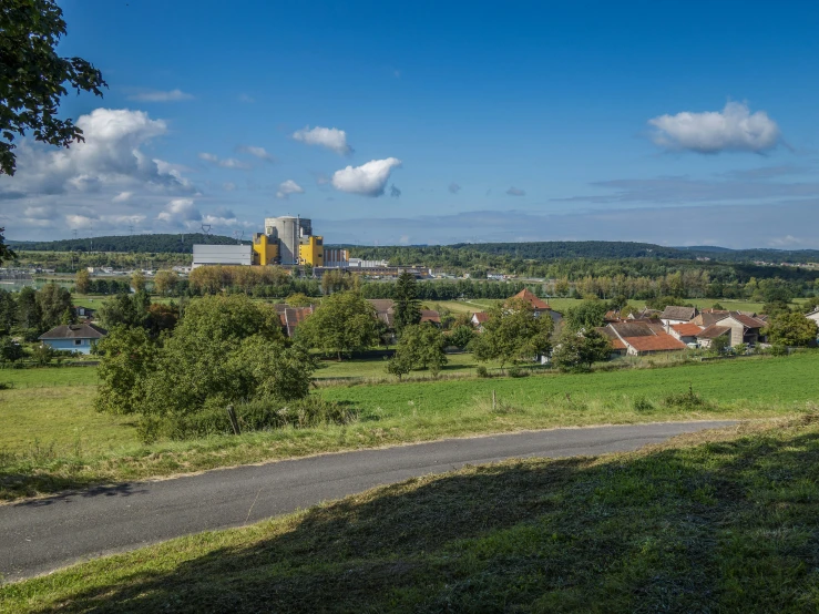 an image of city on the outskirts of a grassy field