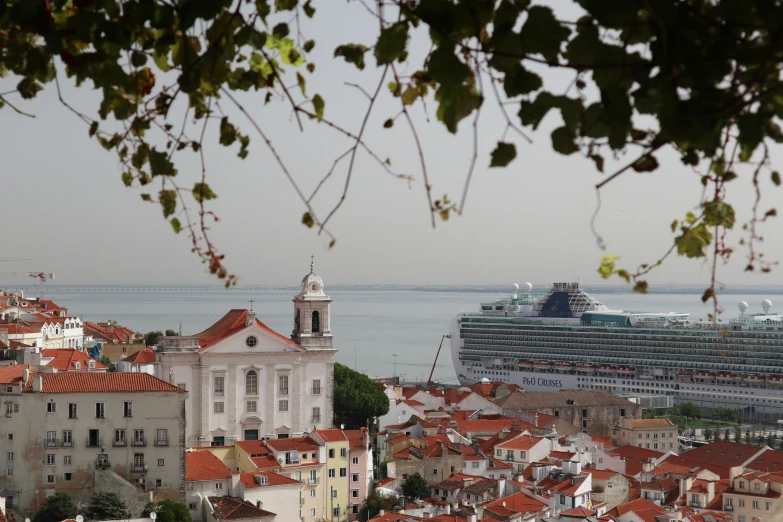 some buildings a cruise ship and some water