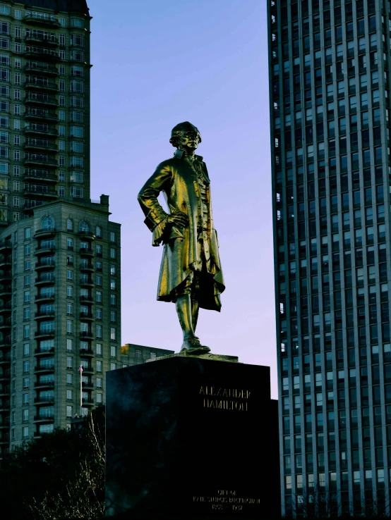 the statue stands among skyscrs of the financial district