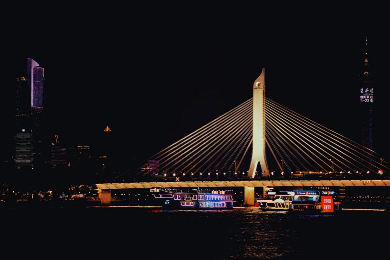 a large white bridge over water in a dark city