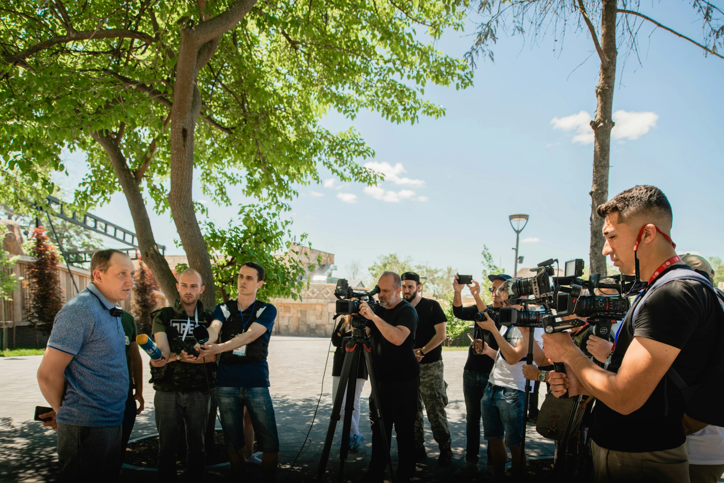 a group of men standing around a camera