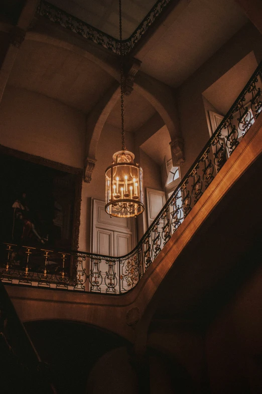 the ceiling light is hanging above the staircase