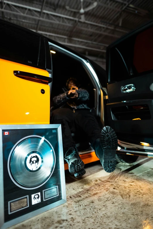 a man sitting inside a large vehicle with his feet propped up in the passenger door