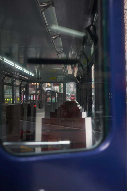 the inside of a blue bus looking out from it