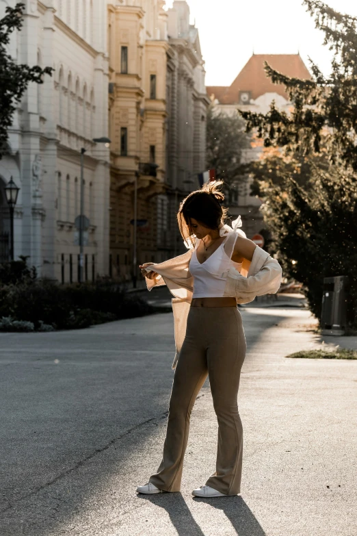 an image of woman in white shirt and wide leg pants