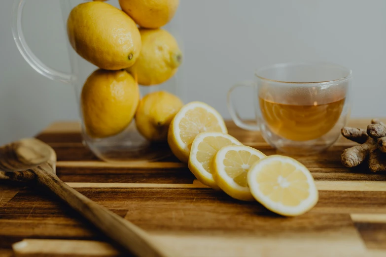 lemons, ginger root, and a tea cup on a  board