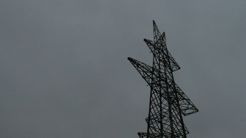 the tower is high in the sky on a foggy day