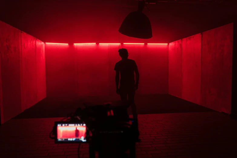 a man in a room with red lights