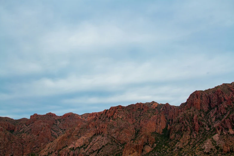 the mountains with a small patch of clouds in the background