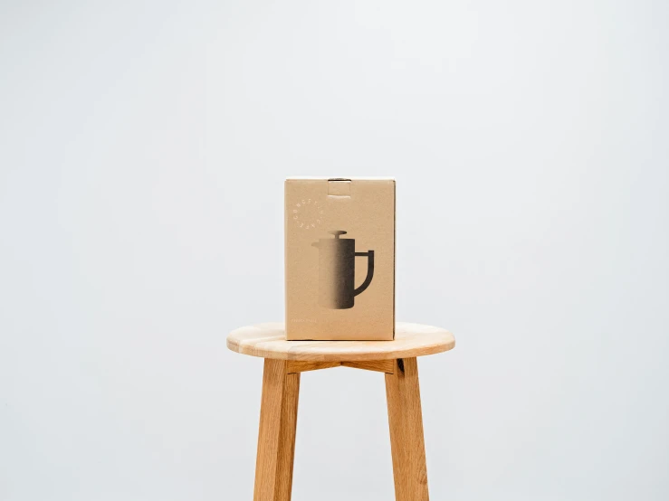 an open brown bag sitting on top of a wooden stool